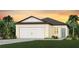 Inviting single-Gathering home featuring a two-car garage, tidy lawn and tropical landscaping at 8303 Sw 54Th Loop, Ocala, FL 34481