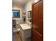 Bright bathroom featuring a modern vanity and beautiful wood door at 149 County Road 640, Lake Wales, FL 33859