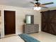 Bedroom featuring wood-look accent wall and sliding barn door at 149 County Road 640, Lake Wales, FL 33859