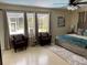 Comfortable bedroom boasts natural light, stylish decor, and cozy seating near screened windows at 149 County Road 640, Lake Wales, FL 33859