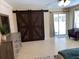 View of bedroom featuring sliding barn door and stylish dresser with decor at 149 County Road 640, Lake Wales, FL 33859