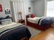 Cozy bedroom with twin beds, natural light, and wood floors at 149 County Road 640, Lake Wales, FL 33859