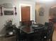 Dining area featuring a dark wood dining table, comfortable chairs and decorative wall decor at 149 County Road 640, Lake Wales, FL 33859