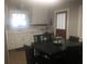 Eat-in kitchen with stainless steel appliances, white cabinetry and a large wooden dining table at 149 County Road 640, Lake Wales, FL 33859