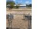 View of the property featuring a chain link gate, storage structure, and grounds at 149 County Road 640, Lake Wales, FL 33859