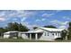 Charming single-story home featuring light blue siding, a metal roof and a covered porch at 149 County Road 640, Lake Wales, FL 33859