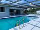 Clear, clean pool in a screened enclosure with patio seating and pool equipment for easy maintenance at 149 County Road 640, Lake Wales, FL 33859