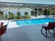 Beautiful in-ground pool with a covered patio area and clean, bright white tiling all around at 149 County Road 640, Lake Wales, FL 33859