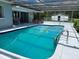 Sparkling swimming pool with a screened enclosure, featuring a diving board and plenty of space for recreation at 149 County Road 640, Lake Wales, FL 33859