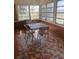 Cozy sunroom with a vintage table and chairs, tile floors, and bright, natural light at 149 County Road 640, Lake Wales, FL 33859