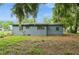 Backyard view showcasing mature trees and a partially shaded yard at 1727 Bonita Ave, Orlando, FL 32805