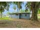 Backyard featuring lush trees, providing ample shade and a serene outdoor space at 1727 Bonita Ave, Orlando, FL 32805