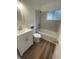 Updated bathroom with a shower-tub combo, new flooring, a modern vanity, and a tile surround at 1727 Bonita Ave, Orlando, FL 32805