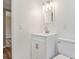 Modern bathroom with a new vanity, light fixture, and toilet, showcasing a clean design at 1727 Bonita Ave, Orlando, FL 32805