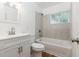 Clean bathroom featuring a vanity, toilet, and bathtub with tiled walls and updated fixtures at 1727 Bonita Ave, Orlando, FL 32805