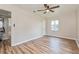 Cozy bedroom with wood floors, a ceiling fan, and a convenient closet, perfect for relaxation at 1727 Bonita Ave, Orlando, FL 32805