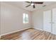 Bedroom with a window and closet featuring stylish wood-look flooring and neutral paint at 1727 Bonita Ave, Orlando, FL 32805