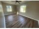 Bright bedroom featuring new floors and two large windows providing ample natural light at 1727 Bonita Ave, Orlando, FL 32805