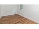 Empty room featuring wood-look floors, neutral walls, baseboard trim, and a window at 1727 Bonita Ave, Orlando, FL 32805