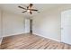 Spacious bedroom featuring wood floors, a modern ceiling fan, and ample natural light at 1727 Bonita Ave, Orlando, FL 32805