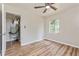 Bright bedroom with a ceiling fan, window, and wood-look floors, offering comfort and style at 1727 Bonita Ave, Orlando, FL 32805