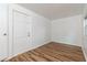 Small empty room featuring wood-look floors, neutral walls, baseboard trim, and an entrance door at 1727 Bonita Ave, Orlando, FL 32805