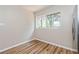 Bright bedroom featuring stylish wood-look flooring and a large window at 1727 Bonita Ave, Orlando, FL 32805