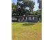 Charming single-story home featuring a cozy front porch, well-maintained lawn, and a vibrant red front door at 1727 Bonita Ave, Orlando, FL 32805