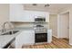 Updated kitchen featuring white cabinets, granite counters, and stainless steel appliances at 1727 Bonita Ave, Orlando, FL 32805