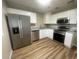 Modern kitchen featuring stainless steel appliances, granite countertops, and sleek white cabinets at 1727 Bonita Ave, Orlando, FL 32805