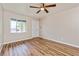Bright living room showcasing wood-look floors, neutral walls, and a ceiling fan fixture at 1727 Bonita Ave, Orlando, FL 32805