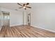 A bright living room featuring wood-look floors, neutral walls, and a contemporary ceiling fan at 1727 Bonita Ave, Orlando, FL 32805
