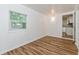 Cozy living room featuring a window, stylish flooring, and an open layout at 1727 Bonita Ave, Orlando, FL 32805