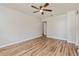 Open living room showcasing wood-look floors, neutral walls, and a modern ceiling fan fixture at 1727 Bonita Ave, Orlando, FL 32805