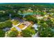 An aerial view of homes and a lake surrounded by lush trees and green space at 2214 Deerbrook Dr, Lakeland, FL 33811