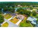 Aerial view of three houses with pools and lake view, showcasing the neighborhood at 2214 Deerbrook Dr, Lakeland, FL 33811