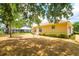 Property features a large backyard with mature trees, offering both shade and privacy at 2214 Deerbrook Dr, Lakeland, FL 33811