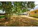 A swing is visible in this spacious backyard featuring mature trees and plenty of natural light at 2214 Deerbrook Dr, Lakeland, FL 33811