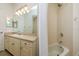 A bathroom featuring a vanity with cabinets and a shower-tub combo at 2214 Deerbrook Dr, Lakeland, FL 33811
