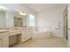 Bathroom featuring dual sinks, bathtub, and glass-enclosed shower at 2214 Deerbrook Dr, Lakeland, FL 33811