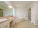 Bathroom featuring dual sinks, bathtub, and glass-enclosed shower at 2214 Deerbrook Dr, Lakeland, FL 33811