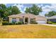 Charming home with a manicured lawn and a two-car garage on a bright, sunny day at 2214 Deerbrook Dr, Lakeland, FL 33811