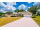 Lovely single-story home featuring a pristine lawn and extended driveway to garage at 2214 Deerbrook Dr, Lakeland, FL 33811