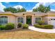 Charming home featuring a welcoming entrance, well-manicured landscaping, and a neatly kept front yard at 2214 Deerbrook Dr, Lakeland, FL 33811