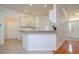 Open-concept kitchen with ample counter space, white cabinetry, a breakfast bar, and seamless flow into the living areas at 2214 Deerbrook Dr, Lakeland, FL 33811