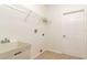 A laundry room featuring a utility sink, wire shelving, and a tile floor at 2214 Deerbrook Dr, Lakeland, FL 33811