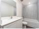 Bright bathroom featuring white cabinets, a tub and shower combo, and tile surround at 3832 Corsican Pl, Lake Alfred, FL 33850