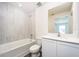 Well-lit bathroom with modern fixtures, including a tub, sink, and toilet at 3832 Corsican Pl, Lake Alfred, FL 33850