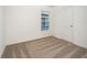 Cozy bedroom featuring neutral carpet and a window for natural light at 3832 Corsican Pl, Lake Alfred, FL 33850