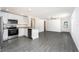 Bright kitchen with stainless steel appliances, white cabinets, granite countertops and an open view to living area at 3832 Corsican Pl, Lake Alfred, FL 33850